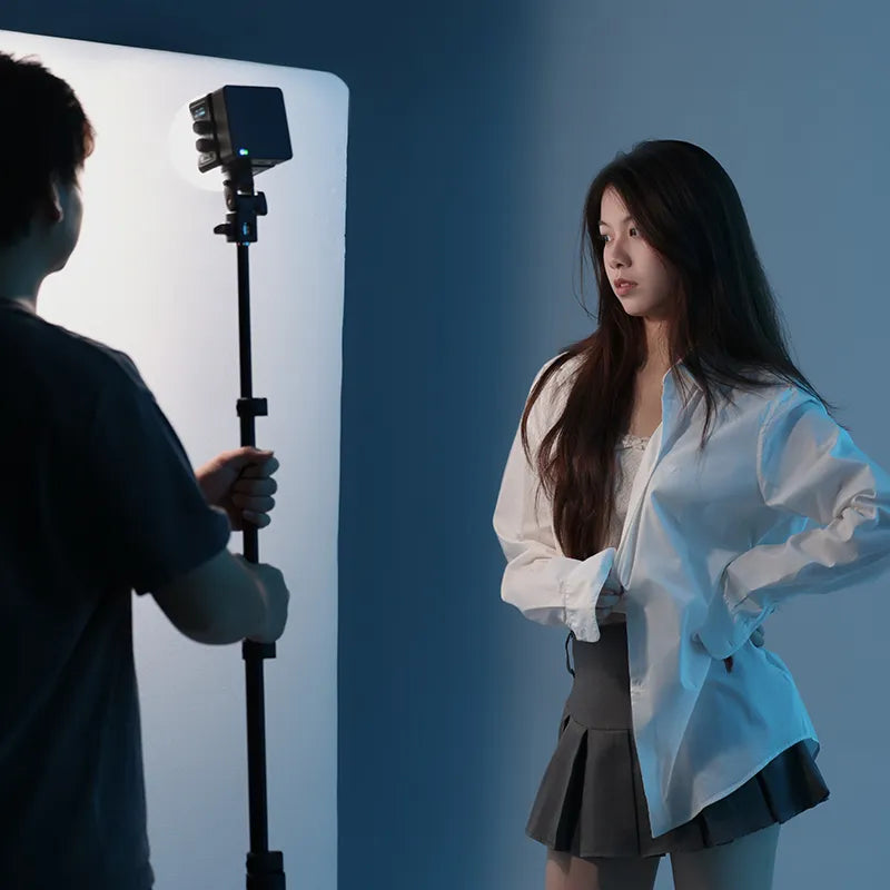 Ulanzi EC65 LED video light used in video shooting setup, woman posing.